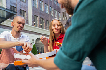 Image showing Group of friends taking a stroll on city\'s street in summer day