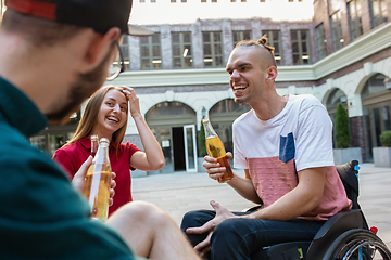 Image showing Group of friends taking a stroll on city\'s street in summer day