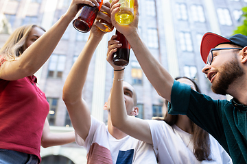 Image showing Group of friends taking a stroll on city\'s street in summer day