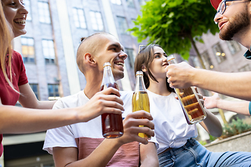 Image showing Group of friends taking a stroll on city\'s street in summer day