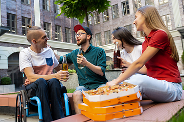 Image showing Group of friends taking a stroll on city\'s street in summer day