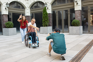 Image showing Group of friends taking a stroll on city\'s street in summer day