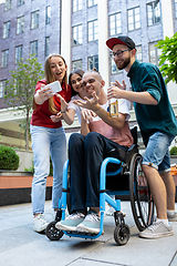 Image showing Group of friends taking a stroll on city\'s street in summer day