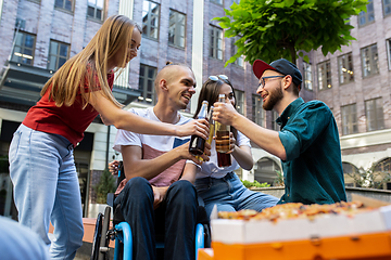 Image showing Group of friends taking a stroll on city\'s street in summer day