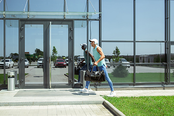 Image showing Sports man against modern glassed building, airport in megapolis