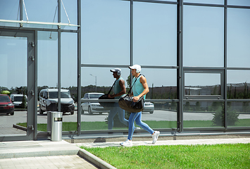 Image showing Sports man against modern glassed building, airport in megapolis