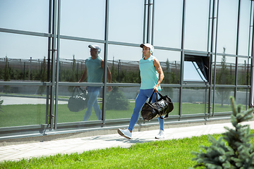 Image showing Sports man against modern glassed building, airport in megapolis