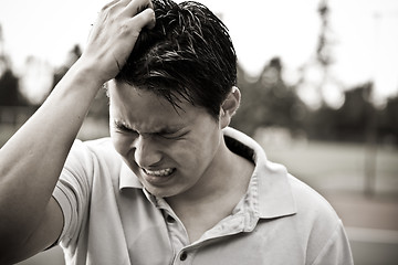 Image showing Sad and stressed young asian male