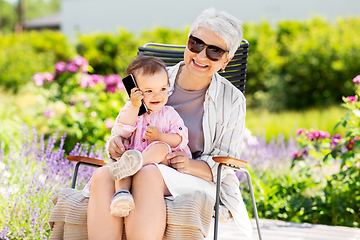 Image showing grandmother and baby granddaughter with smartphone