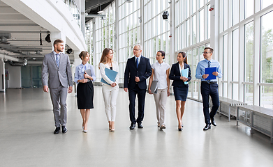 Image showing business people walking along office building