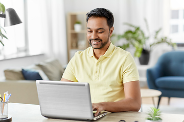 Image showing indian man with laptop working at home office