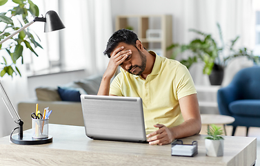 Image showing indian man with laptop working at home office