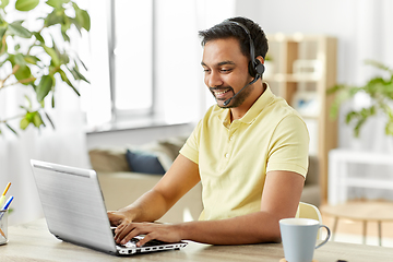 Image showing indian man with headset and laptop working at home