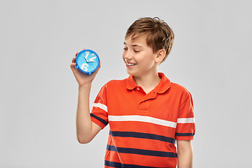 Image showing portrait of happy smiling boy with alarm clock