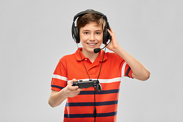 Image showing boy in headphones with gamepad playing video game