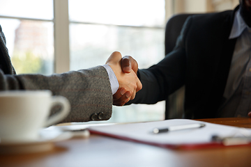 Image showing Close up of businessmen shaking hands in conference room