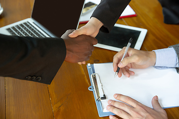 Image showing Close up of businessmen shaking hands in conference room