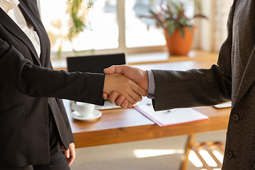 Image showing Close up of businessmen shaking hands in conference room