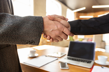 Image showing Close up of businessmen shaking hands in conference room