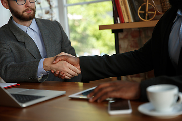 Image showing Close up of businessmen shaking hands in conference room