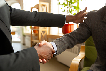 Image showing Close up of businessmen shaking hands in conference room