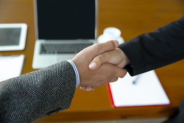 Image showing Close up of businessmen shaking hands in conference room