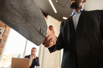 Image showing Close up of businessmen shaking hands in conference room