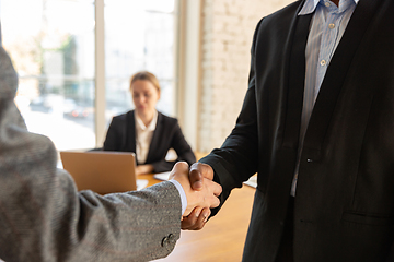 Image showing Close up of businessmen shaking hands in conference room