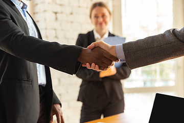 Image showing Close up of businessmen shaking hands in conference room