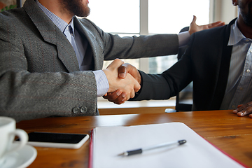 Image showing Close up of businessmen shaking hands in conference room