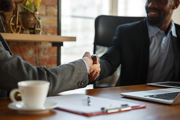 Image showing Close up of businessmen shaking hands in conference room