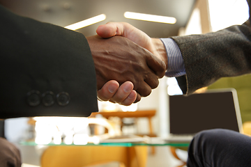 Image showing Close up of businessmen shaking hands in conference room