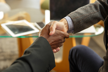 Image showing Close up of businessmen shaking hands in conference room