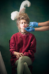 Image showing Young woman as Marie Antoinette on dark background. Retro style, comparison of eras concept.