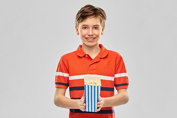 Image showing smiling boy eating popcorn