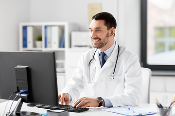 Image showing male doctor with computer working at hospital