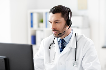 Image showing male doctor with computer and headset at hospital