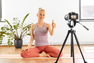 Image showing woman with camera streaming for yoga blog at home