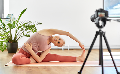 Image showing woman with camera streaming for yoga blog at home