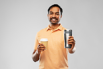 Image showing man comparing thermo cup or tumbler and coffee cup