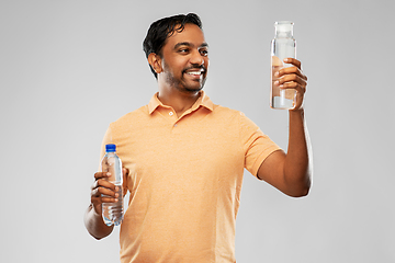 Image showing indian man comparing water in different bottles