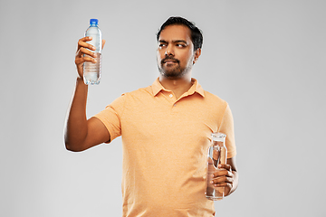 Image showing indian man comparing water in different bottles