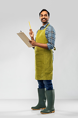 Image showing happy indian gardener or farmer with clipboard