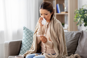 Image showing sick woman measuring temperature by thermometer