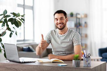 Image showing happy man with laptop working at home office