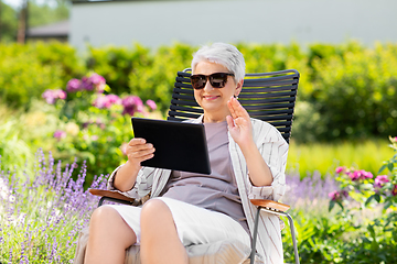 Image showing happy senior woman with tablet pc at summer garden