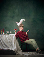 Image showing Young woman as Marie Antoinette on dark background. Retro style, comparison of eras concept.