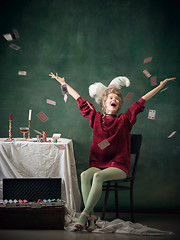 Image showing Young woman as Marie Antoinette on dark background. Retro style, comparison of eras concept.