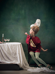 Image showing Young woman as Marie Antoinette on dark background. Retro style, comparison of eras concept.