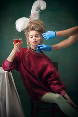 Image showing Young woman as Marie Antoinette on dark background. Retro style, comparison of eras concept.